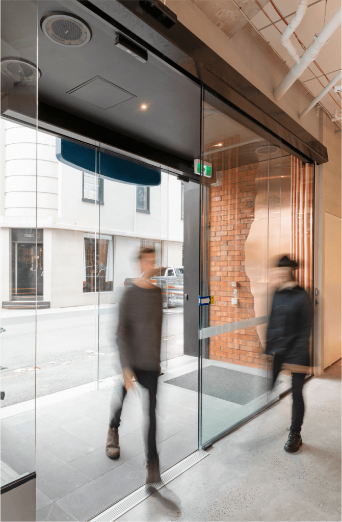 People walking through the Airlock at the building's entrance